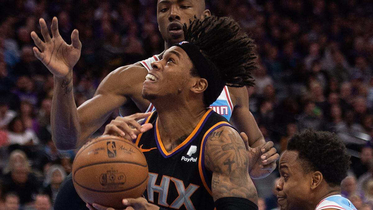 Phoenix Suns forward Richaun Holmes (21) battles Sacramento Kings guard Yogi Ferrell (3) and forward Harry Giles (20) at Golden 1 Center on Sunday, Feb. 10, 2019 in Sacramento.