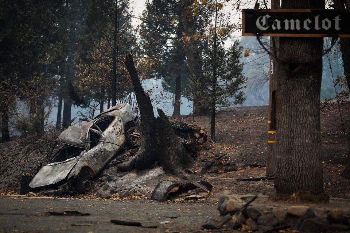 A car is seen burned on the side of Concow Road following the Camp Fire in Concow, California, on Tuesday, Nov. 13, 2018.