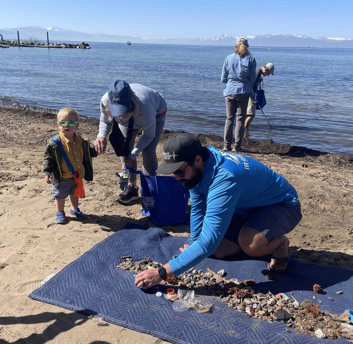JT Chevallier sifts through debris picked up by the BeBot, a French-made robot that cleans beaches, in Kings Beach on July 5, 2023.