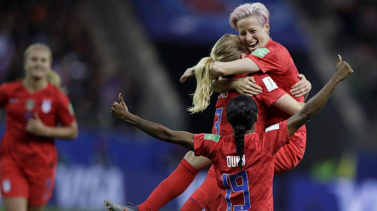 American Samantha Mewis lifts her teammate Megan Rapinoe as she celebrates her team’s fourth goal during the Women’s World Cup game in Reims, France, Tuesday.