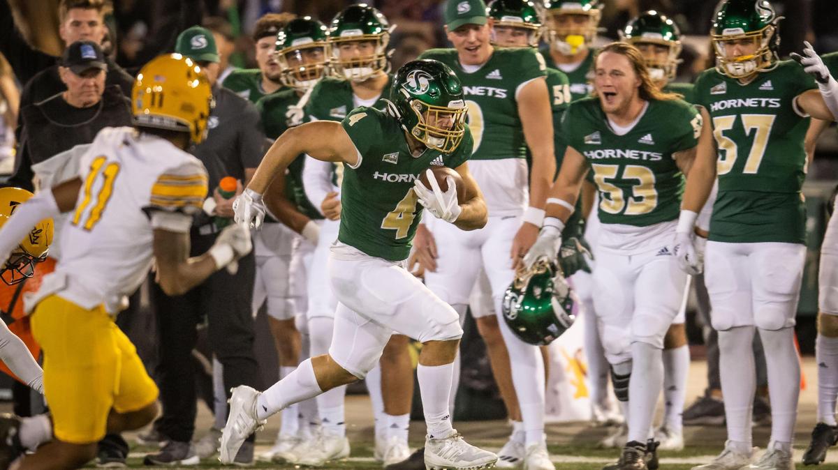 Sacramento State Hornets running back Cameron Skattebo (4) runs for big gain as he is cheered from the sideline during the second quarter against the Idaho Vandals at the NCAA college football game Saturday, Oct. 29, 2022, at Hornet Stadium in Sacramento.