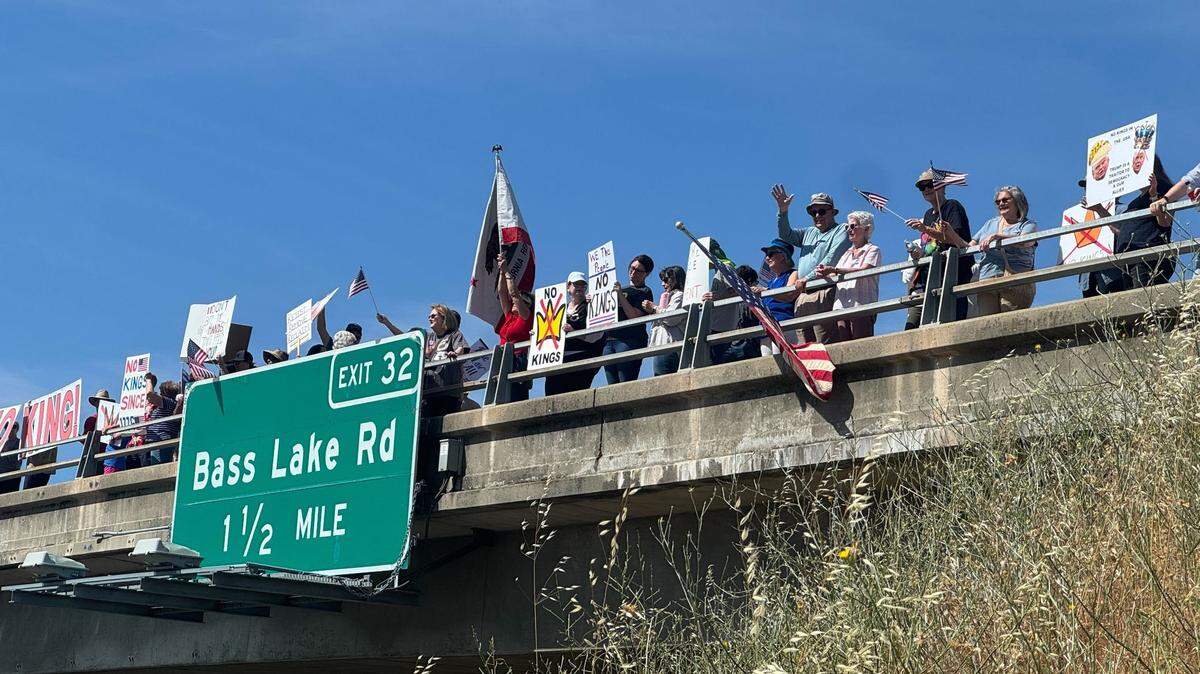 More than 130 protesters gather at the Cambridge Overpass in Cameron Park in support of ‘No Kings,’ joining hundreds of others across El Dorado County.