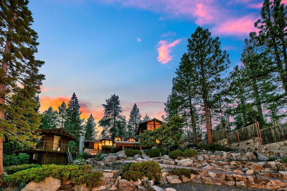 Terraced gardens, indigenous plantings and tiled walkways create a seamless connection to the landscape, with views of the lake at every turn.