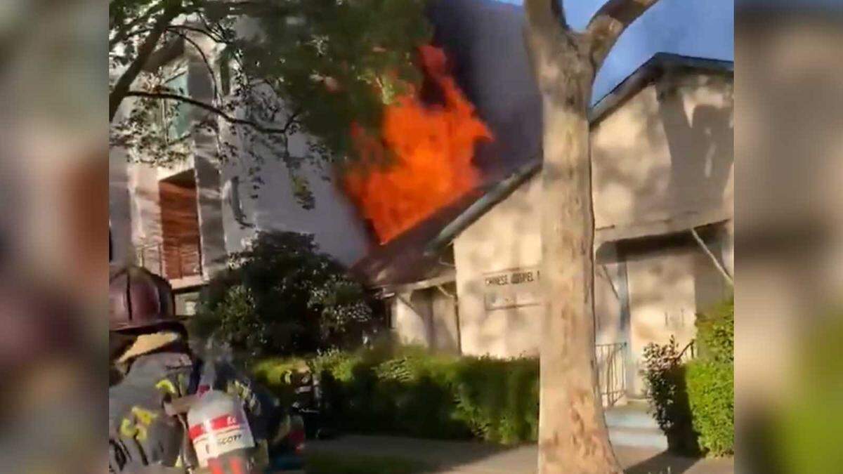 Flames are seen coming from the south side of the Chinese Gospel Mission on 15th Street in downtown Sacramento on Saturday, April 10, 2021.