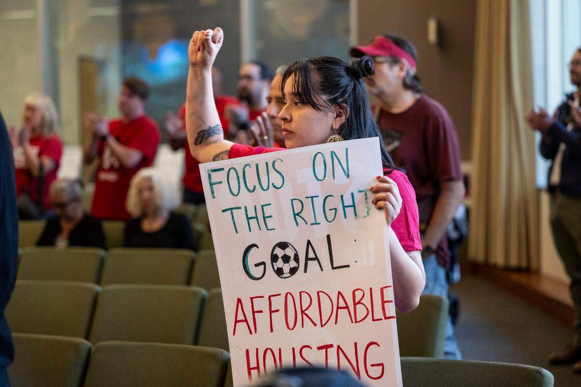 Gaby Varela, a union member of Unite Here Local 49, protests at the Railyards Public Financing Authority meeting in the Sacramento City Council chamber on Tuesday.