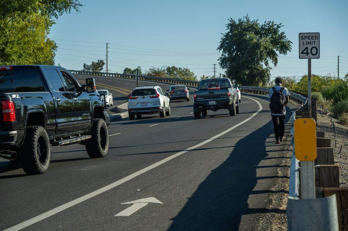 Jahison Tracy, a junior at Creative Connections Arts Academy, walks close to the guardrail while walking home on Walerga Road from Creative Connections Arts Academy high school in North Highlands in October. He said he and his sister, also a student, are scared of the walk. “I’m terrified of it,” Tracy said.