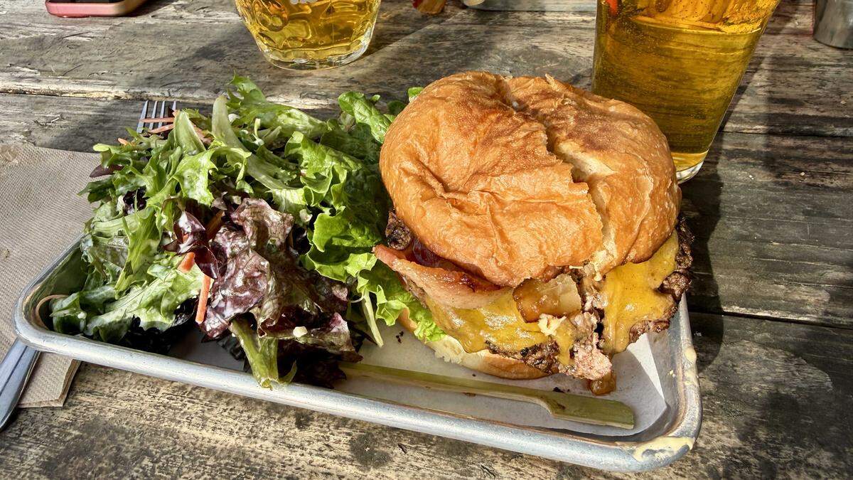 Pangaea's eponymous burger is their flagship offering, seen here alongside salad and a Pliny the Elder. Pangaea will close its doors on Mar. 19 due to a dispute with its landlord.