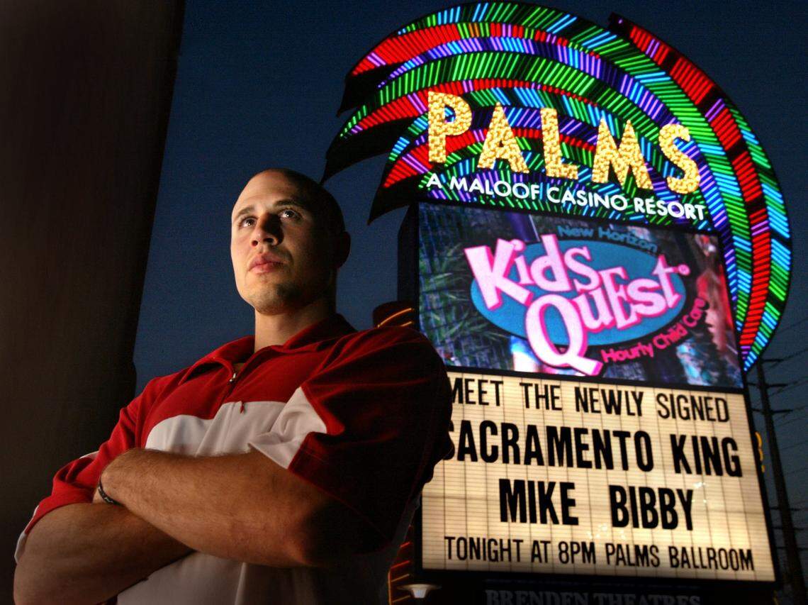 Mike Bibby stands in front of a sign at Palms Casino in Las Vegas introducing him as a Sacramento Kings player after signing an $80 million contract in 2002. The Maloof family that owned the team at the time also owned the casino.