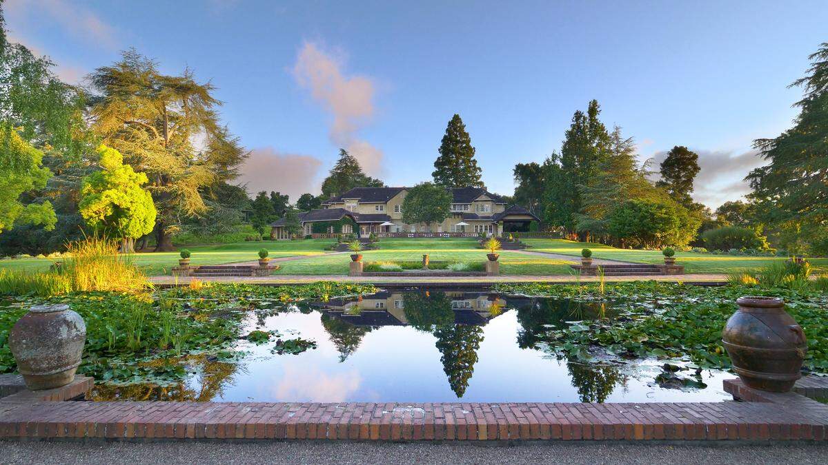 The main English manor home as seen from the pond area, part of the 74-acre estate in Woodside, California.