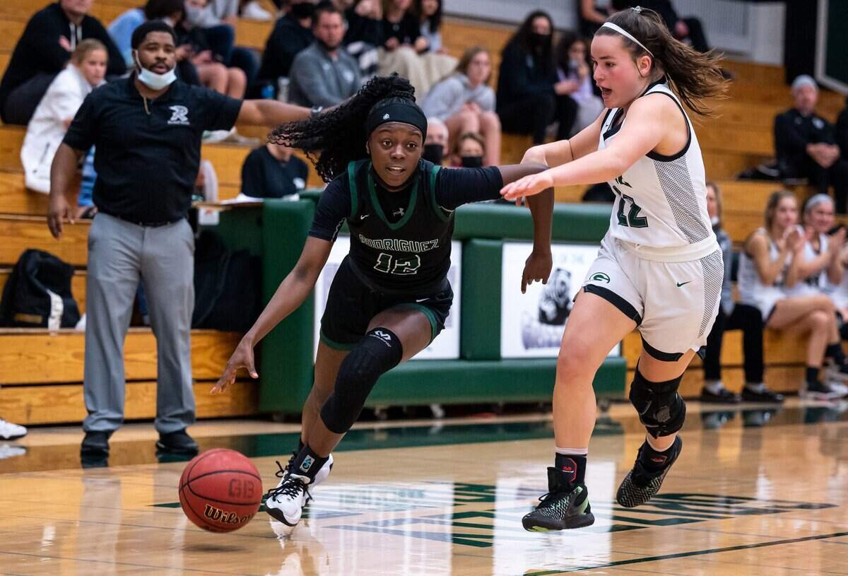 Rodriguez Mustangs’ Camryn Washington (12), left, drives to the basket as Granite Bay Grizzlies’ Reagan Gotham (22) defends during the third period at the high school girls basketball Sac-Joaquin Section playoff game Thursday, Feb. 17, 2022, at Granite Bay High School. Rodriguez came from behind in the second half to beat Granite Bay, 57-50.