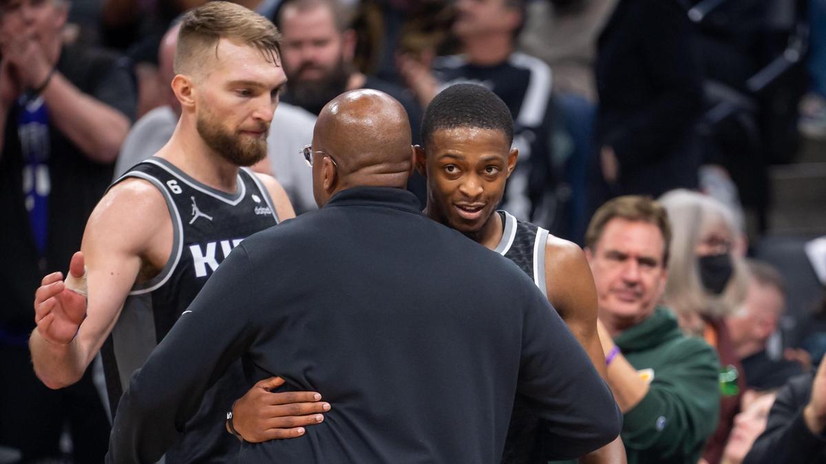Sacramento Kings head coach Mike Brown, center, talks with guard De’Aaron Fox (5), right, and center Domantas Sabonis (10) after a strong performance during the fourth quarter against the Houston Rockets at the NBA basketball game Friday, Jan. 13, 2023, at Golden 1 Center in Sacramento.