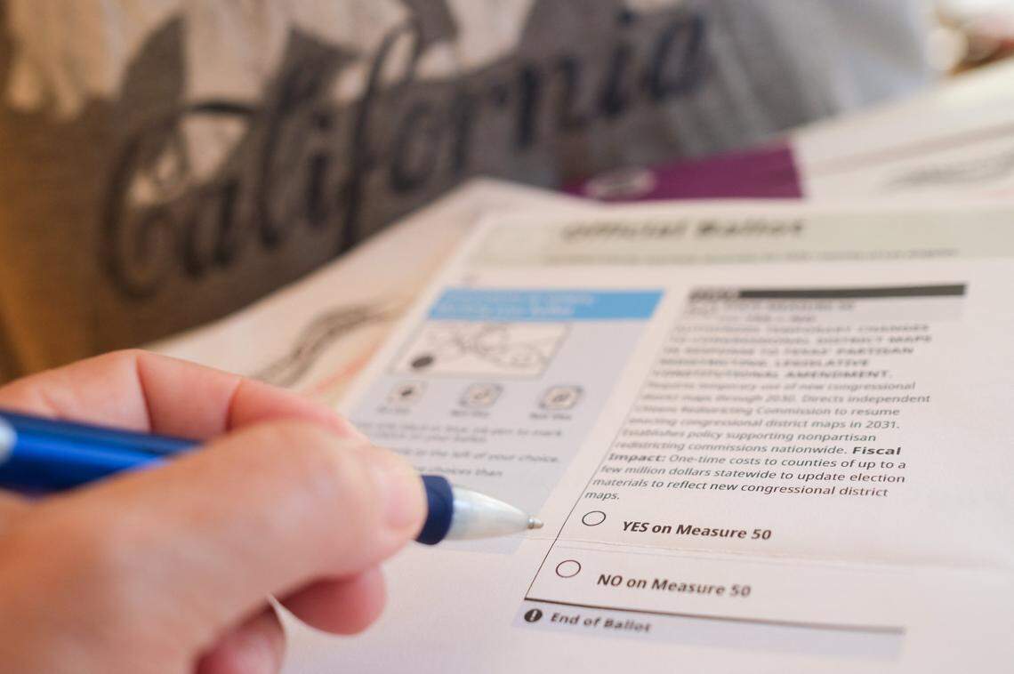 This ilustration photo shows a person filling their ballot for California Proposition 50, also known as the Election Rigging Response Act, in Los Angeles on October 23, 2025. California's November 4, 2025 special election on Proposition 50, is a measure backed by legislative Democrats and Governor Gavin Newsom that, if approved, would redraw the state's congressional districts. (Photo by Chris DELMAS / AFP) (Photo by CHRIS DELMAS/AFP via Getty Images)