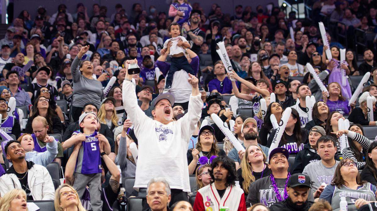 Sacramento Kings’ fans cheer as families hold their children up to get on the Jumbotron during a timeout at the NBA basketball game Sunday, April 2, 2023, at Golden 1 Center. The Spurs won 142-134 in overtime.