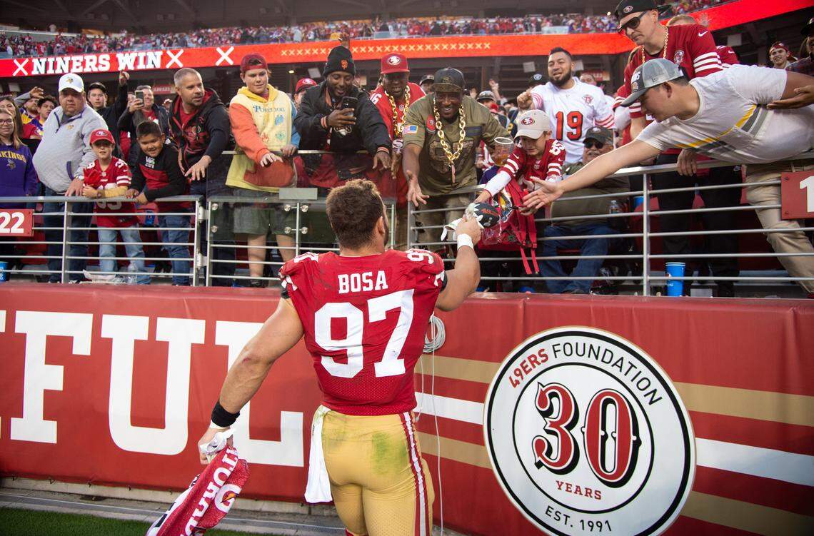San Francisco 49ers defensive end Nick Bosa gives fans his gloves after a 34-26 win over the Minnesota Vikings on Nov. 28, 2021, at Levi's Stadium in Santa Clara.