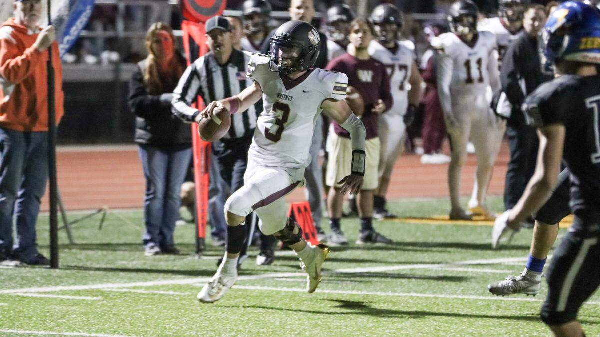 Whitney quarterback Eli Brickhandler navigates through the Lincoln defense on Friday night.