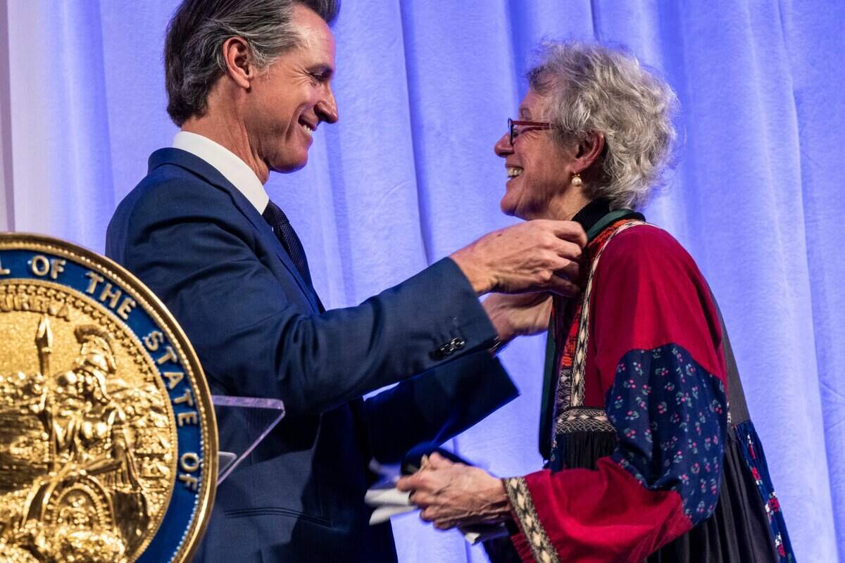 Sociologist Arlie Russell Hochschild receives a medal from Gov. Gavin Newsom during the California Hall of Fame induction ceremony on Tuesday, Dec. 13, 2022 in Sacramento.