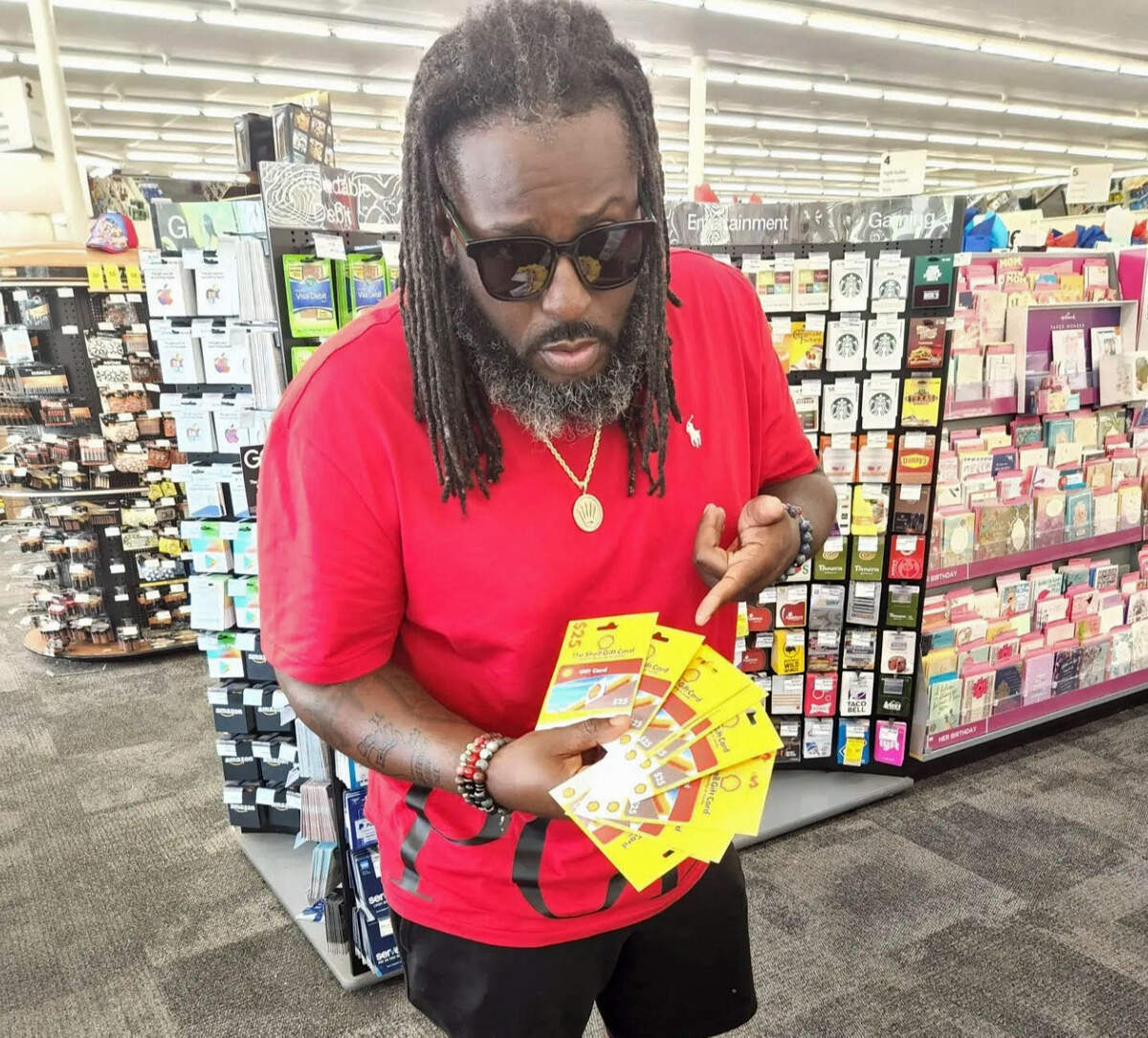 Voice of the Youth founder Berry Accius is seen with gas gift cards on Monday, June 20, 2022. His group handed out gift cards to help offset the high price of gasoline.