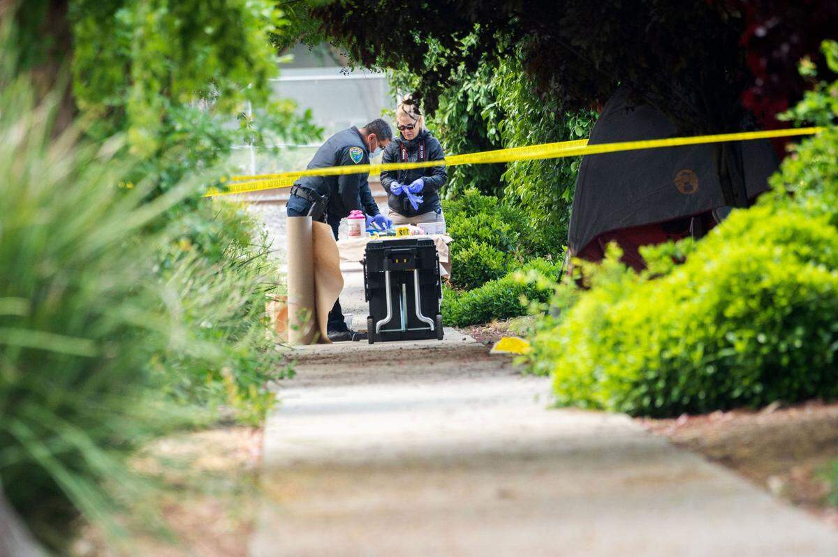 Members of the Davis Police Department investigate on Tuesday, May 2, 2023, the scene where a man stabbed a homeless woman through the side of her tent near Second and L streets before midnight. It was the third stabbing in the city in less than a week. 