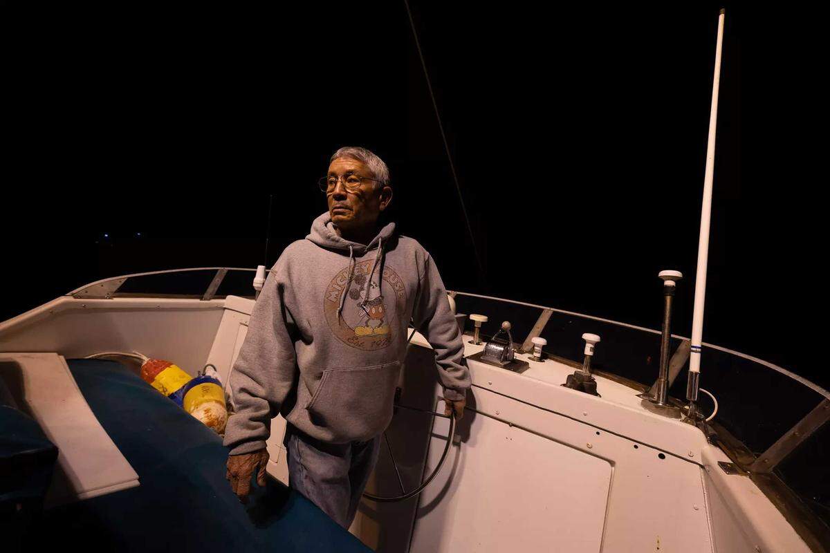 Dick Ogg navigates his boat out of Bodega Bay in the predawn hours of a January morning, setting off for a 16-hour day of crab fishing.