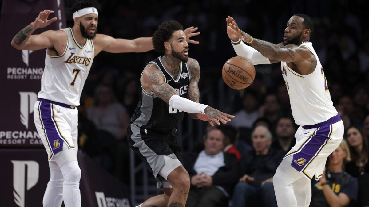 Sacramento Kings’ Willie Cauley-Stein, center, passes the ball as Los Angeles Lakers’ JaVale McGee (7) and LeBron James, right, defend during the first half on Sunday, March 24, 2019, in Los Angeles.