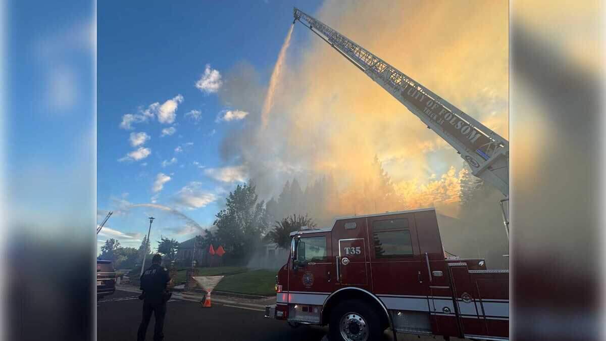 A Folsom Fire Department ladder truck sprays water onto a burning home on River Ridge Way in Folsom on Monday, Sept. 8. Firefighters fought the blaze from a distance due to reports of a potentially armed, barricaded person inside the home.