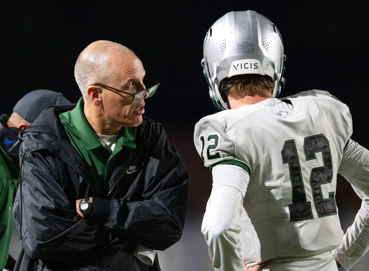 Granite Bay Grizzlies coach Joe Cattolico consults with quarterback Nick Harris (12) during a game against Rocklin last month. The Grizzilies will open the playoffs against No. 12-seeded Pleasant Grove.