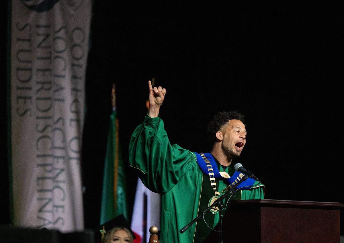 Sacramento State President Luke Wood makes a stingers up sign during his first commencement ceremony at Golden 1 Center on Friday, May 17, 2024.