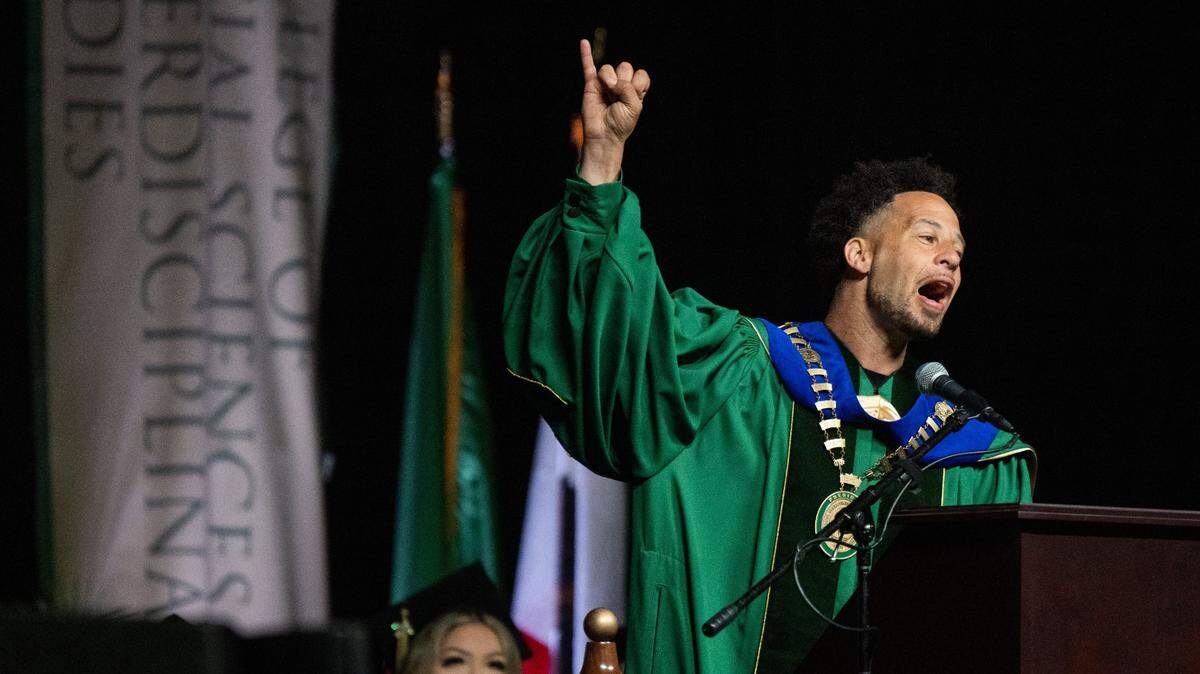 Sacramento State President Luke Wood makes a stingers up sign during his first commencement ceremony at Golden 1 Center on Friday, May 17, 2024. Sacramento State aims to transform Capitol Mall into a mixed-use downtown district, fueling economic growth, housing and research to revive downtown.