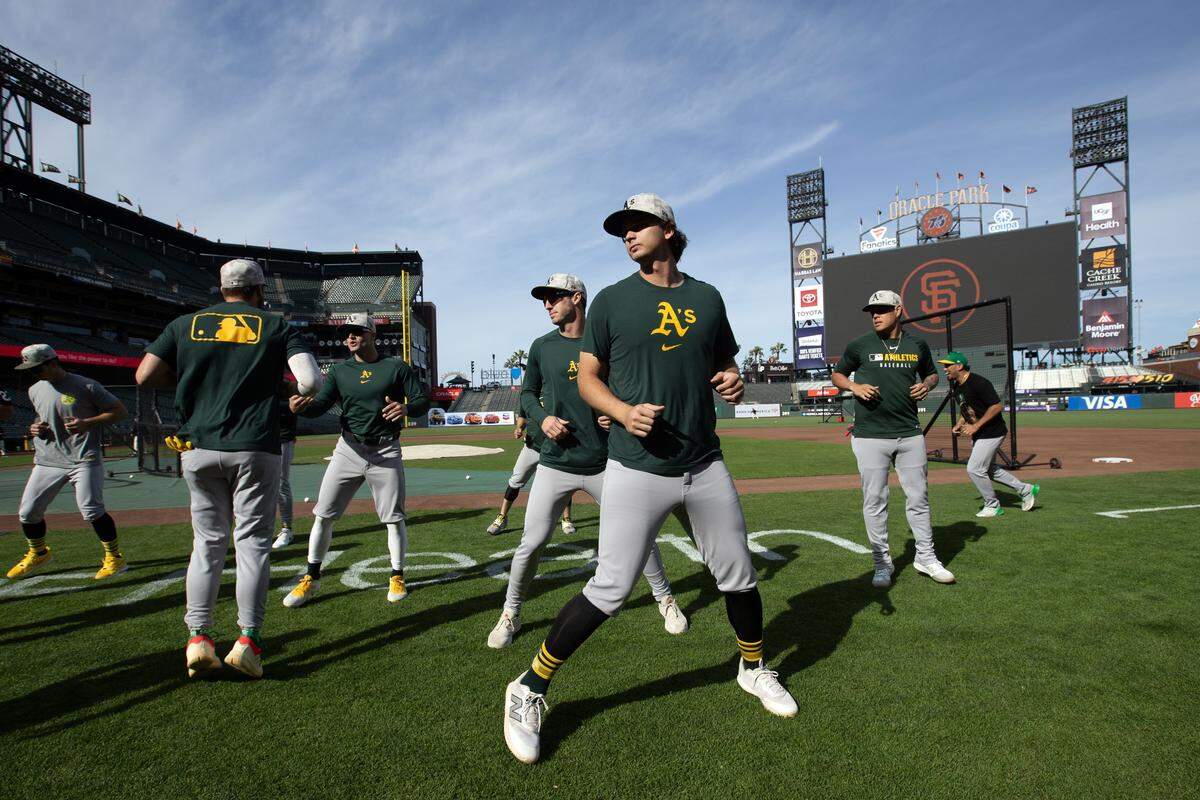 May 16, 2025; San Francisco, California, USA; Athletics players stretch before their game against the San Francisco Giants at Oracle Park. Mandatory Credit: D. Ross Cameron-Imagn Images