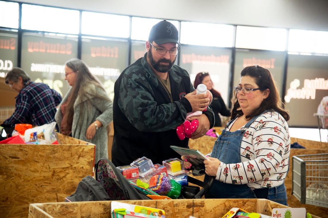 Kelly and Derrick Alhona and daughter Danielle, 1 month, shop for toys and books at Falling Prices discount store in Carmichael on Wednesday, Jan. 23, 2019.