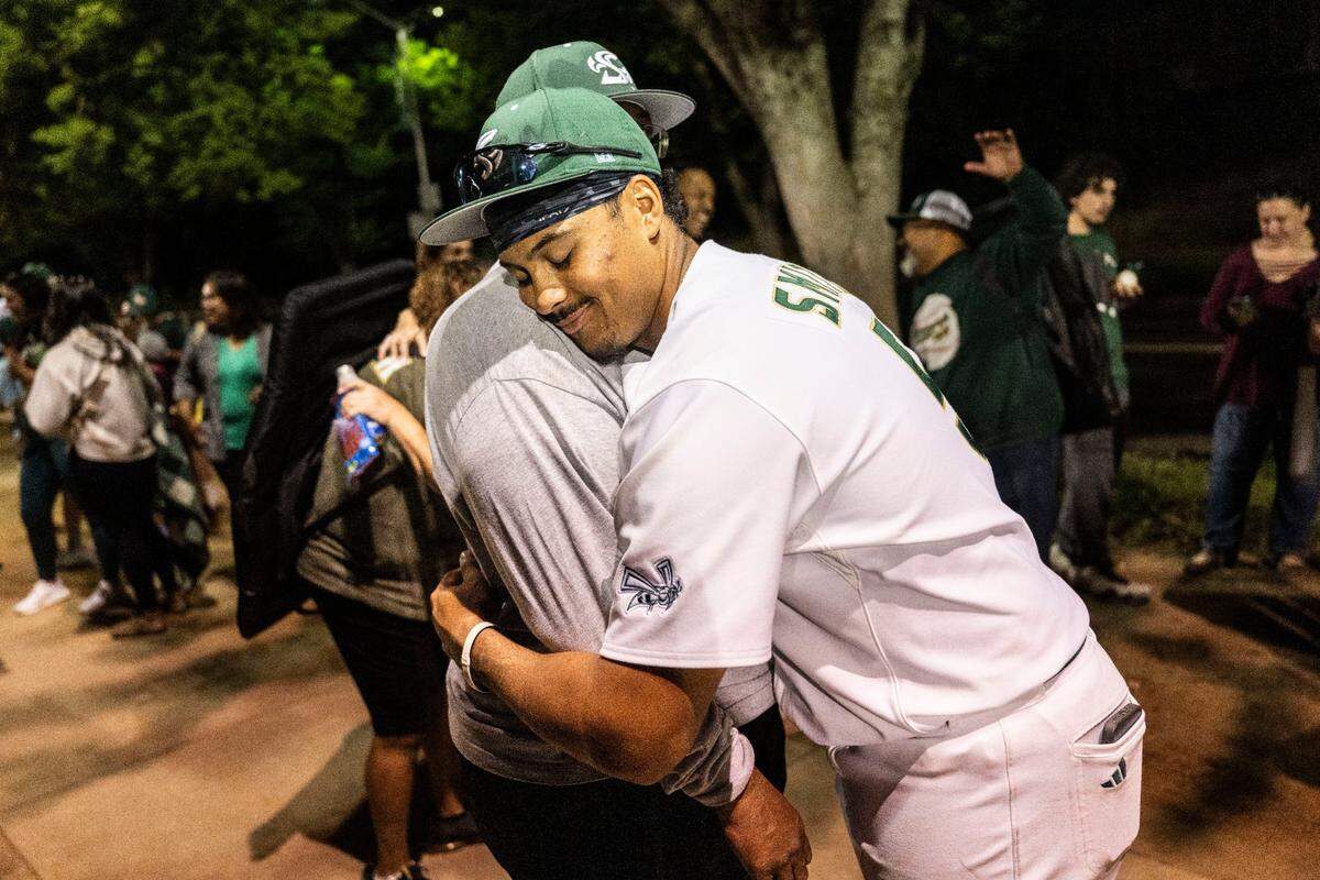 Sacramento State first baseman JP Smith hugs his father JP Smith Sr. after his team’s victory against Utah Tech on Thursday at Sacramento State.