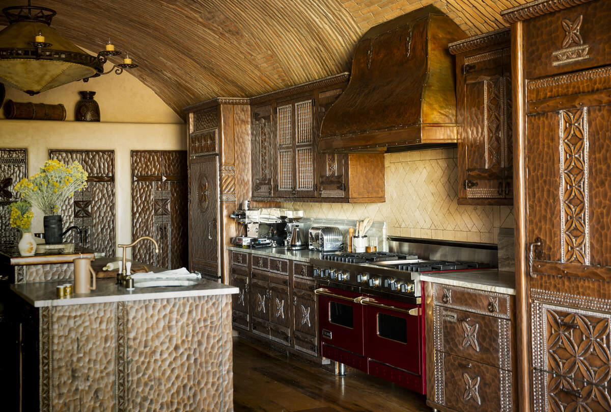 The luxury kitchen in the Santa Fe residence. At the center of the compound is the main hacienda, originally designed by William F. Tull, known for Southwestern adobe architecture.