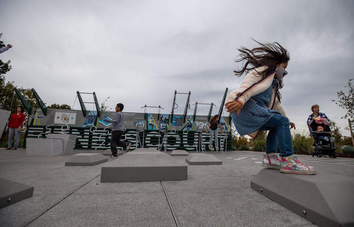 Families explore the fitness court during the grand opening celebration at The Preserve at District 56, Elk Grove’s sprawling new park near the center of the city, on Nov. 6.