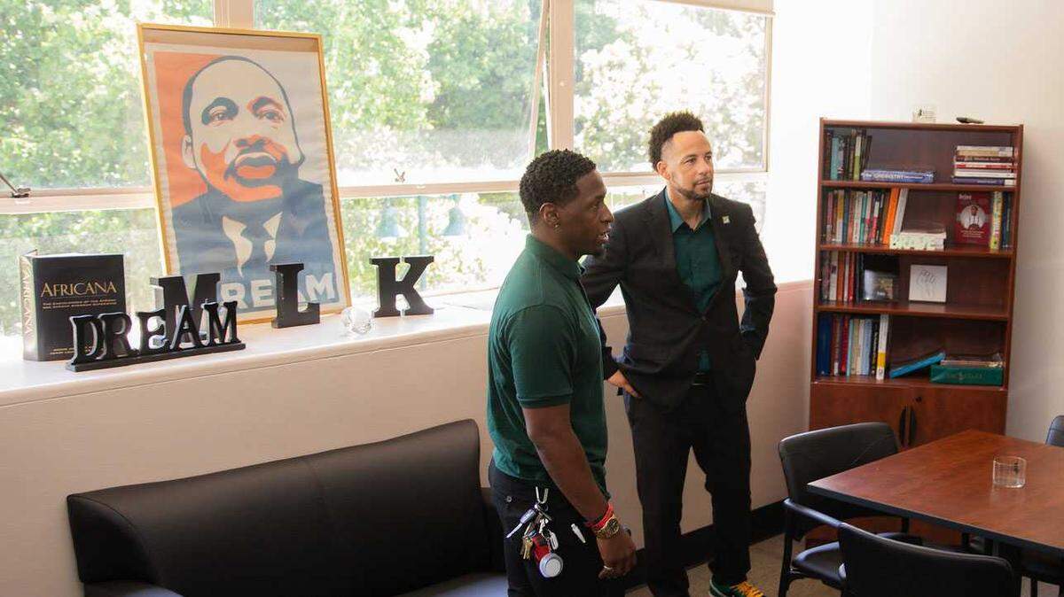 Sacramento State President Luke Wood and Kaifa Yates of the school’s Martin Luther King Jr. Center talk during Wood’s campus tour July 18. Wood announced that the university would become home to a new school designed to support Black and African American students later this year.