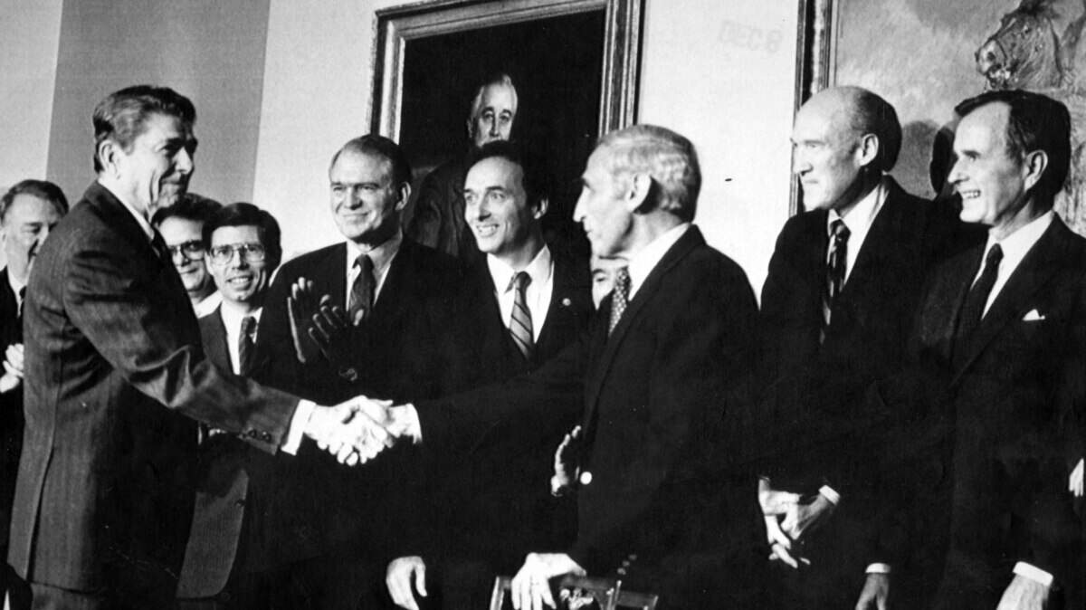 In 1986, then-President Ronald Reagan congatulates Rep. Romano Mazzoli, one of the principal architects of a sweeping immigration reform law.