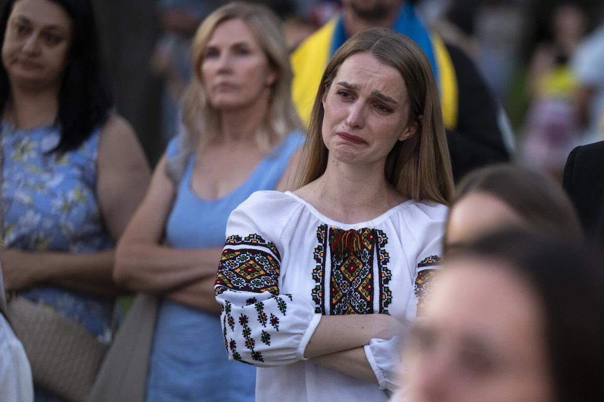 Members of the Ukrainian community react to a slideshow featuring recovering Ukrainian soldiers during a Ukrainian Independence Day celebration at the California Capitol in Sacramento on Sunday.