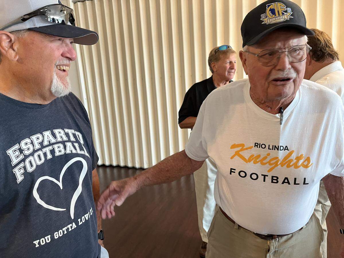 Esparto football coach Ron Cristian, left, pictured Aug. 10 at a National Football Foundation event in Sacramento, often talks to decades-long friend and mentor Frank Negri about the challenges of their sport.