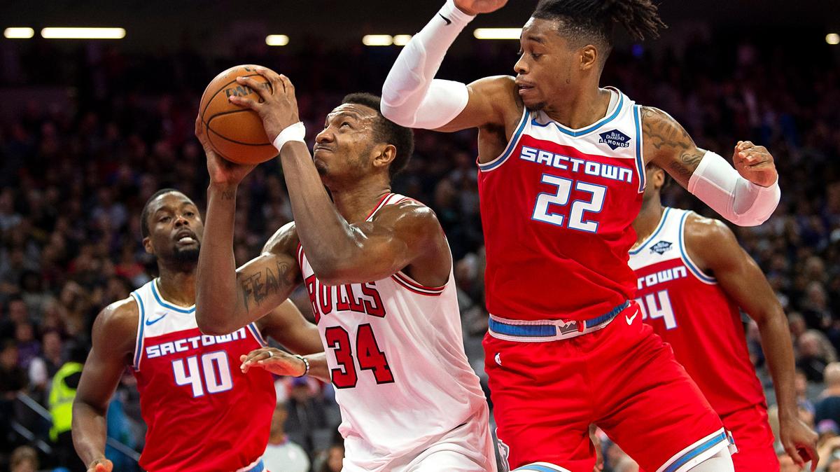 Chicago Bulls center Wendell Carter Jr. (34) shoots between Sacramento Kings forward Richaun Holmes (22) and Sacramento Kings forward Harrison Barnes (40) during a game at Golden 1 Center on Monday, December 2, 2019 in Sacramento.