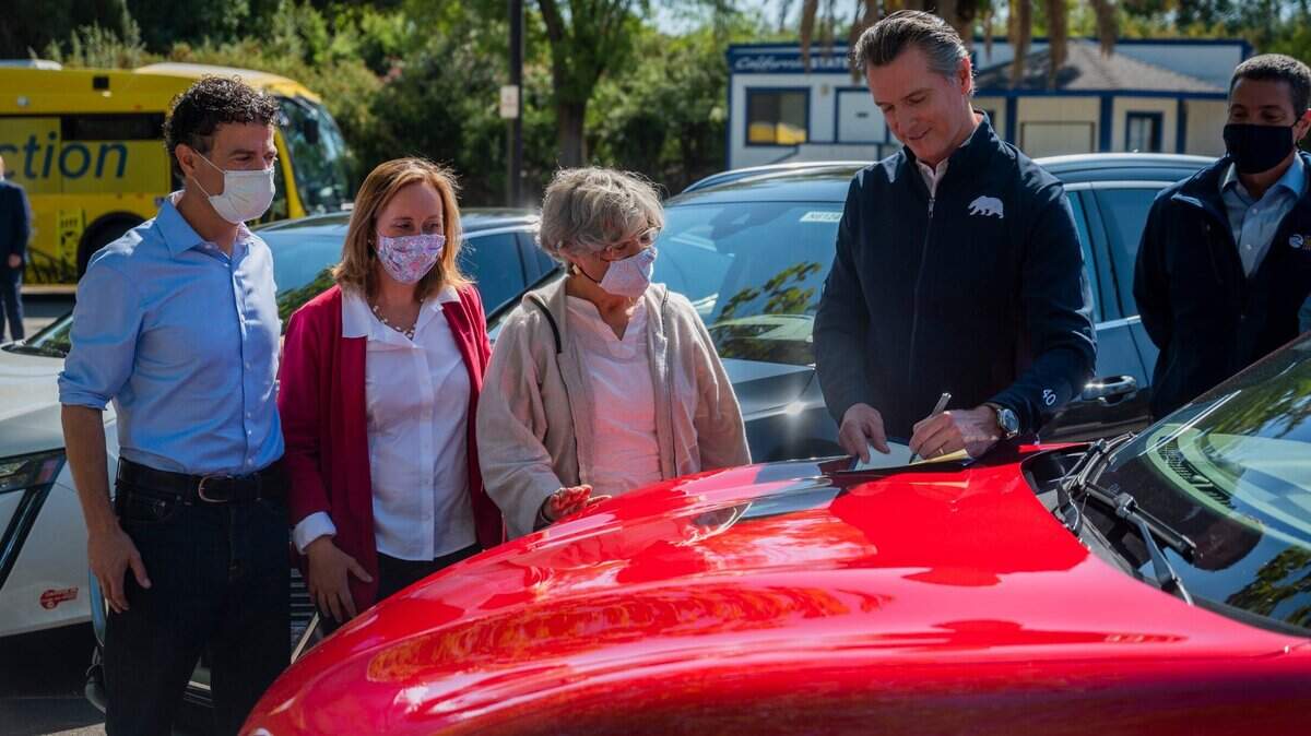 California Gov. Gavin Newsom signs an executive order on a Ford Mustang Mach-E requiring all new passenger vehicles sold in the state to be zero-emission by 2035, a move the governor says would achieve a significant reduction in greenhouse gas emissions, on Wednesday, Sept. 23, 2020, at Cal Expo.