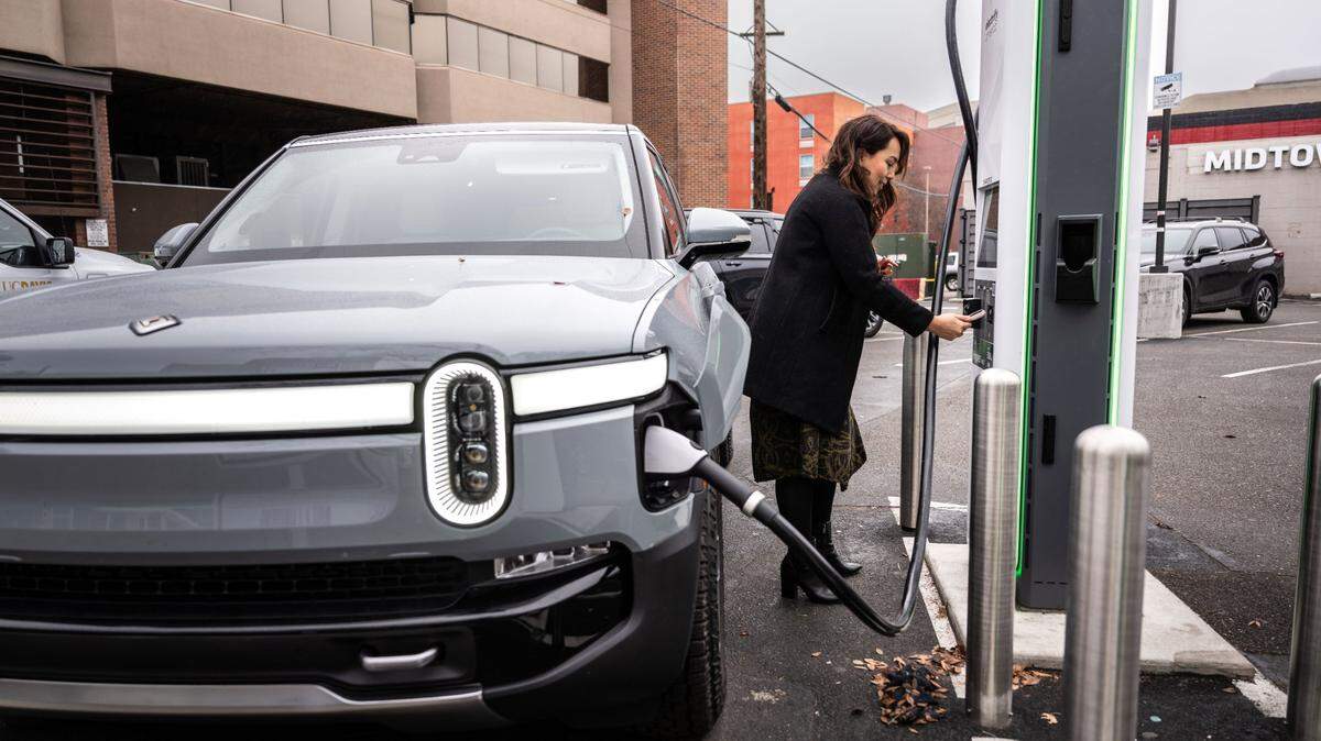 Sacramento resident Angie Manetti charges her Rivian on Tuesday, Jan. 9, 2024, at an Electrify America station in downtown Sacramento. Can California keep leading the electric vehicle transition?
