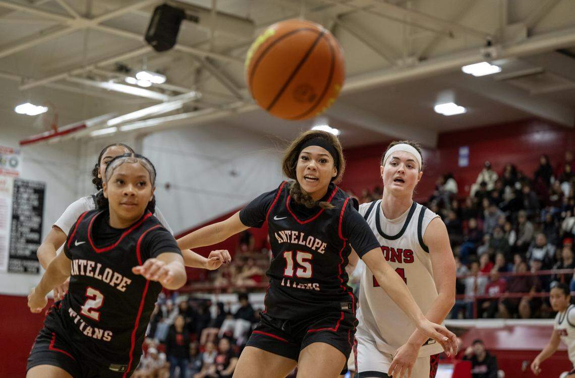 Antelope Titans' Shaylah Taplin (2), Amira Davenport (15) and the McClatchy Lions' Daisy Throckmorton (24) chase after a loose ball in the second half of a game on Friday in Sacramento.