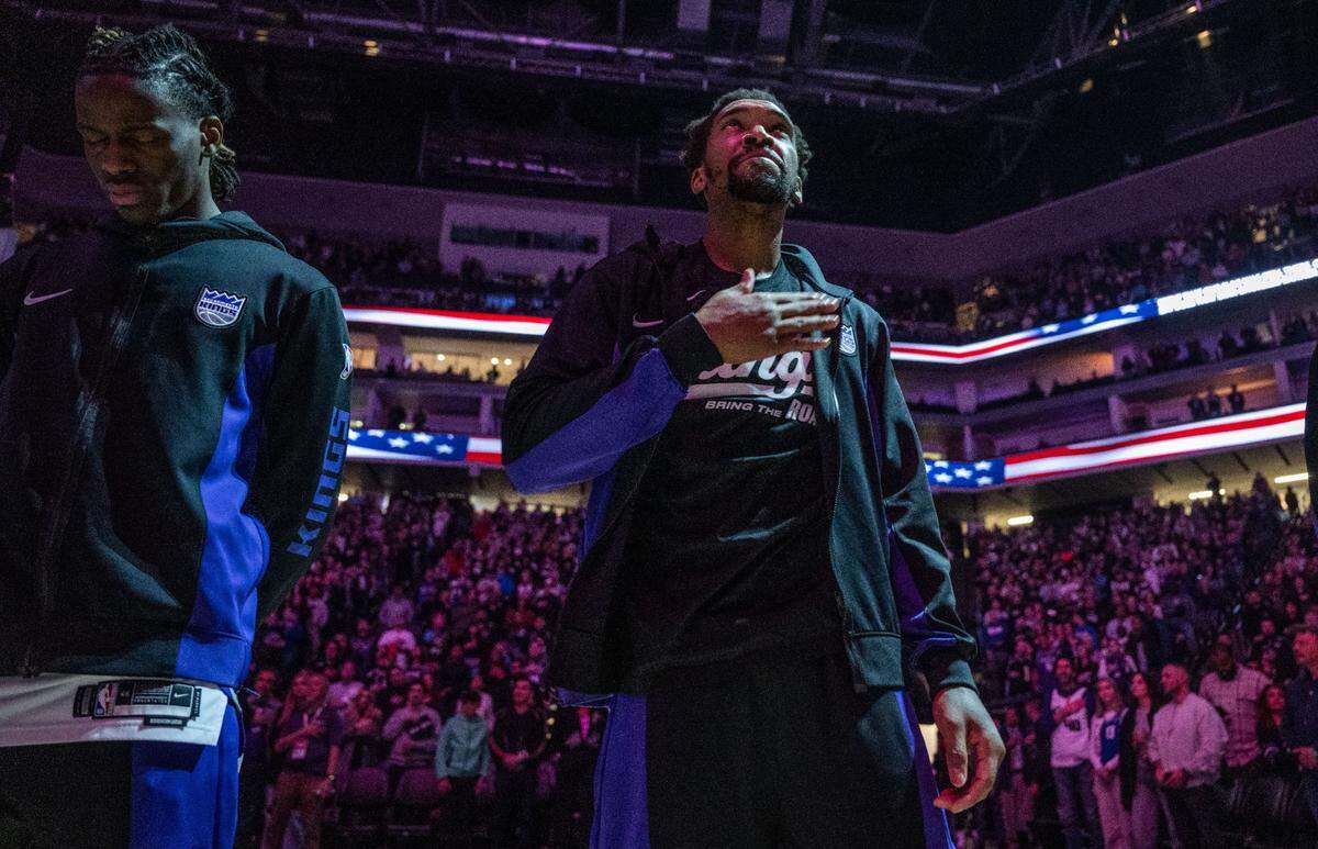 Sacramento Kings guard Malik Monk (0) taps his chest during the National Anthem before the game against the Dallas Mavericks on Friday. Monk is expected to miss 4 to 6 weeks after suffering an MCL sprain in his right knee in the first quarter.