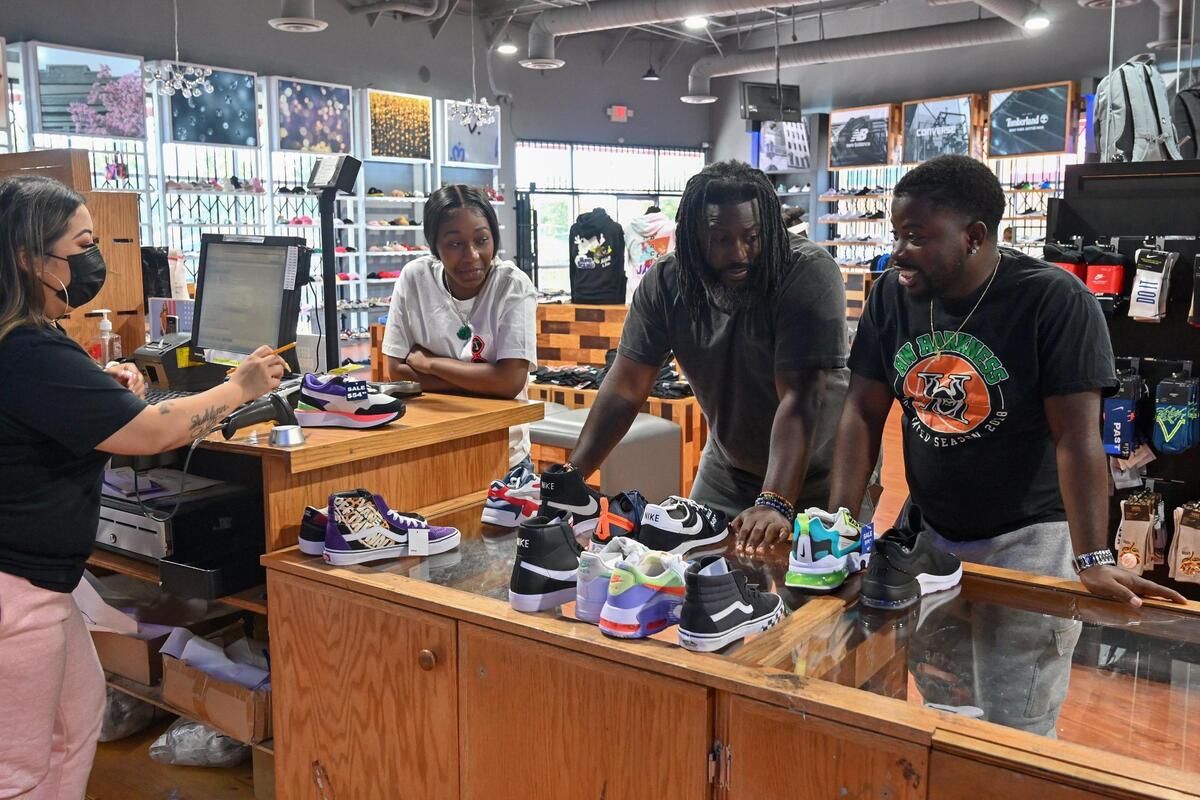 Sheikh assistant manager Lincey Chao, left, helps Malaya Muldrew, 17, Berry Accius, founder of Voice of the Youth and community activist, and Tyler McClure, 28, youth advocate, right, pick out shoes at Sheikh in Sacramento on Wednesday, July 21, 2021, for the upcoming Voice of the Youth shoe drive. This is their first shoe drive and it will take place Sunday from 11 a.m. to 3 p.m. at Hidden Gems Thrift Store.