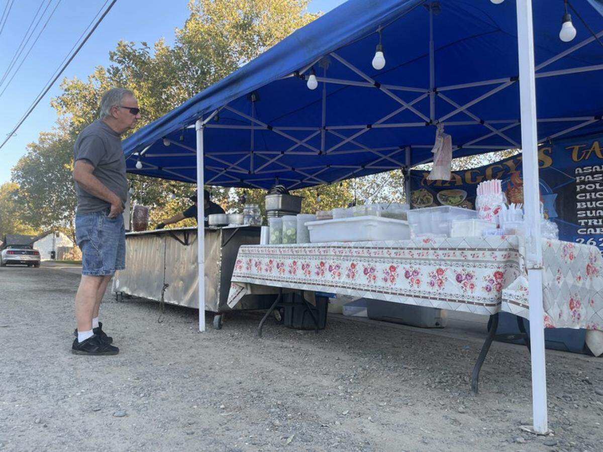 Neal Ferguson orders from a taco stand in Elk Grove on Calvine Road on Wednesday evening. The city is working with vendors to make sure they are operating legally.