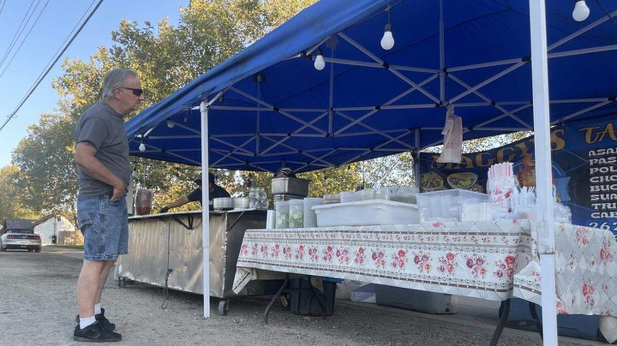 Neal Ferguson orders from a taco stand in Elk Grove on Calvine Road on Wednesday evening. The city is working with vendors to make sure they are operating legally.