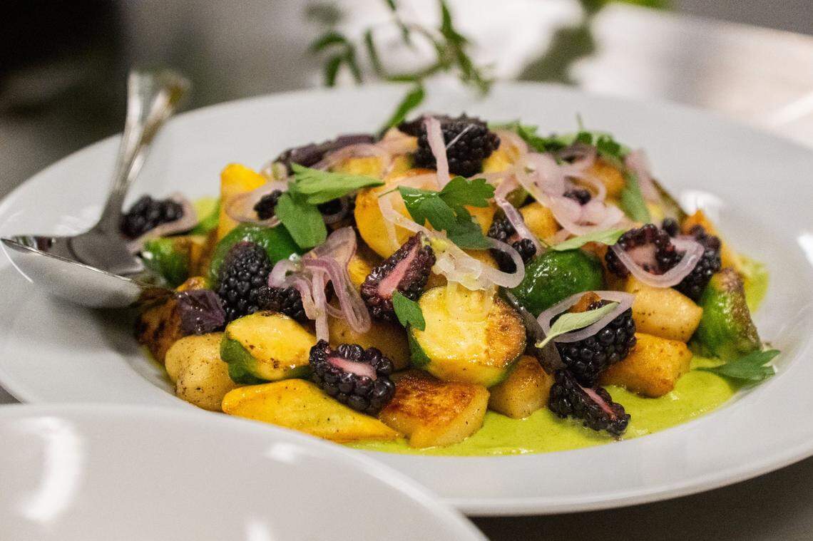 Ricotta gnocchi sits on display during this year’s Tower Bridge Dinner menu preview at the Central Kitchen in Sacramento on Monday, Aug. 12, 2024. This second course, prepared by Ella chef de cuisine Jamie Rathburn, is made with zucchini butter, parsley, roasted zucchini, opal basil, compressed shallots, blackberries and mint garnish.