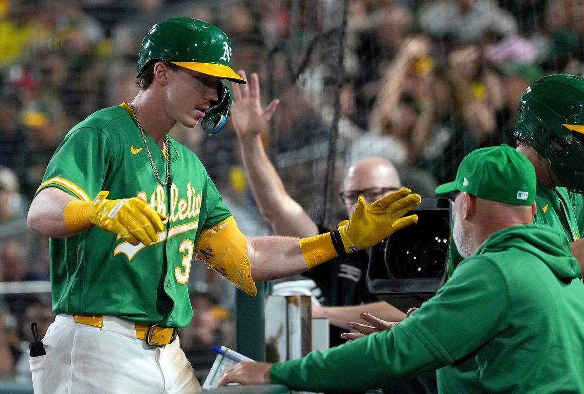 Athletics outfielder Henry Bolte is congratulated by manager Mark Kotsay after Bolte hit a sacrifice fly scoring Nick Kurtz against the St. Louis Cardinals in the bottom of the seventh inning Wednesday at Sutter Health Park in West Sacramento during Bolte’s first MLB game.