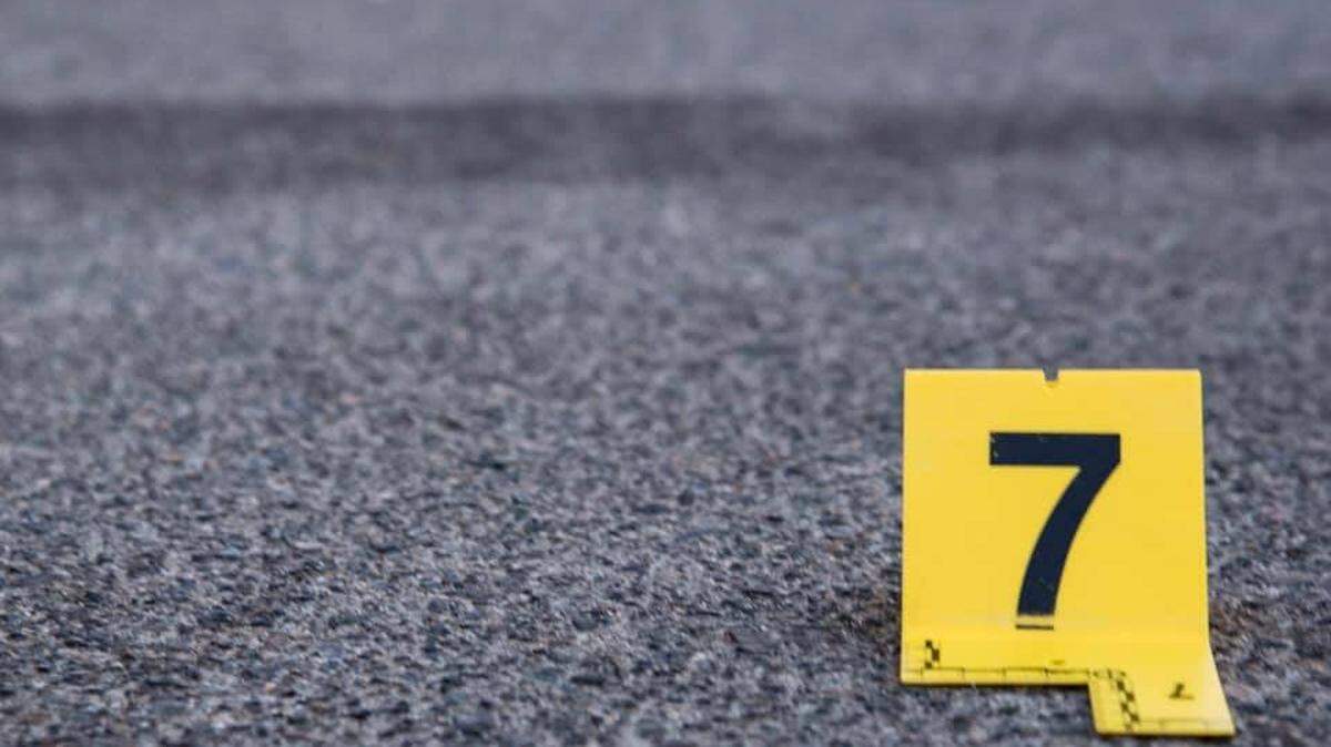In this April 25, 2020, photo, evidence identification markers and a police vehicle are shown. An 18-year-old man was arrested after telling police a bogus story about his friend getting shot in a drive-by shooting on Sept. 5, 2021, in Anaheim, California.