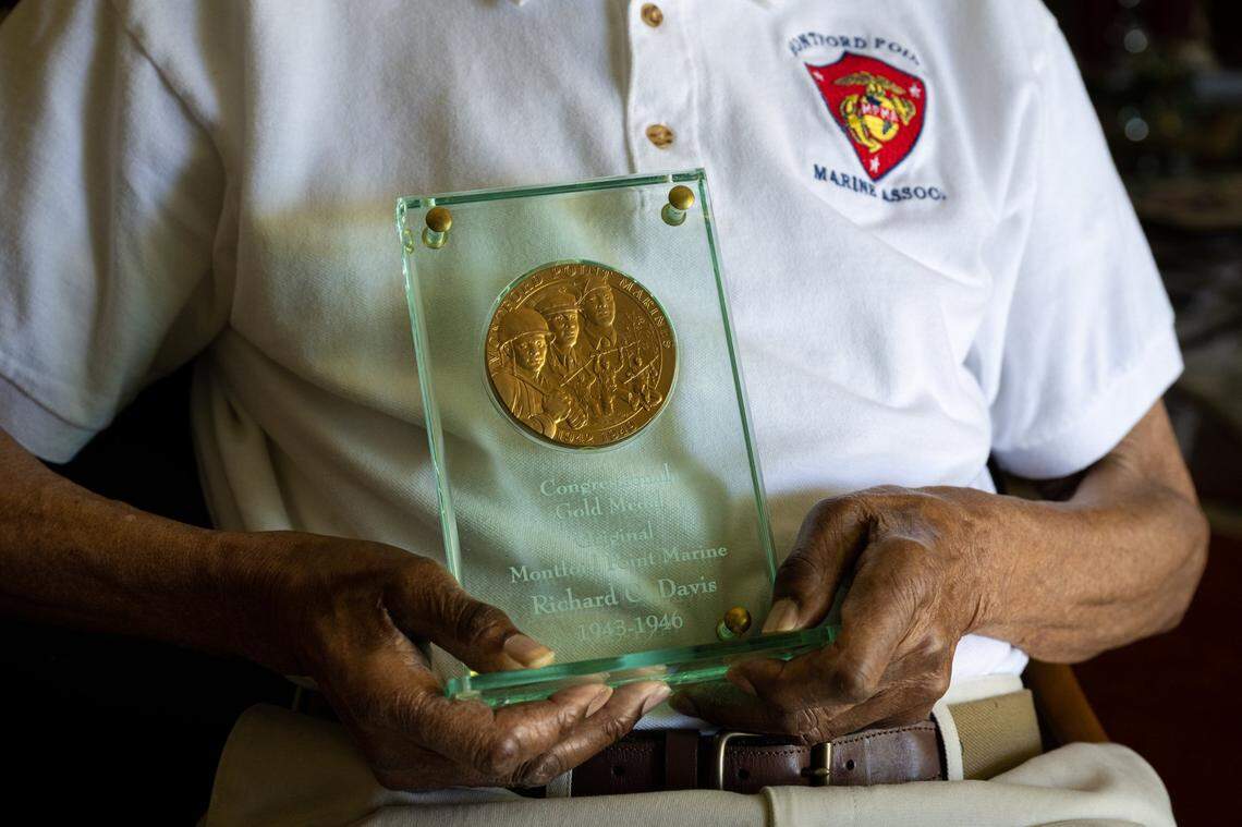 Rich Davis, 97, holds his Congressional Gold Medal Wednesday as one of the last surviving Montford Point Marines, a Black World War II unit.