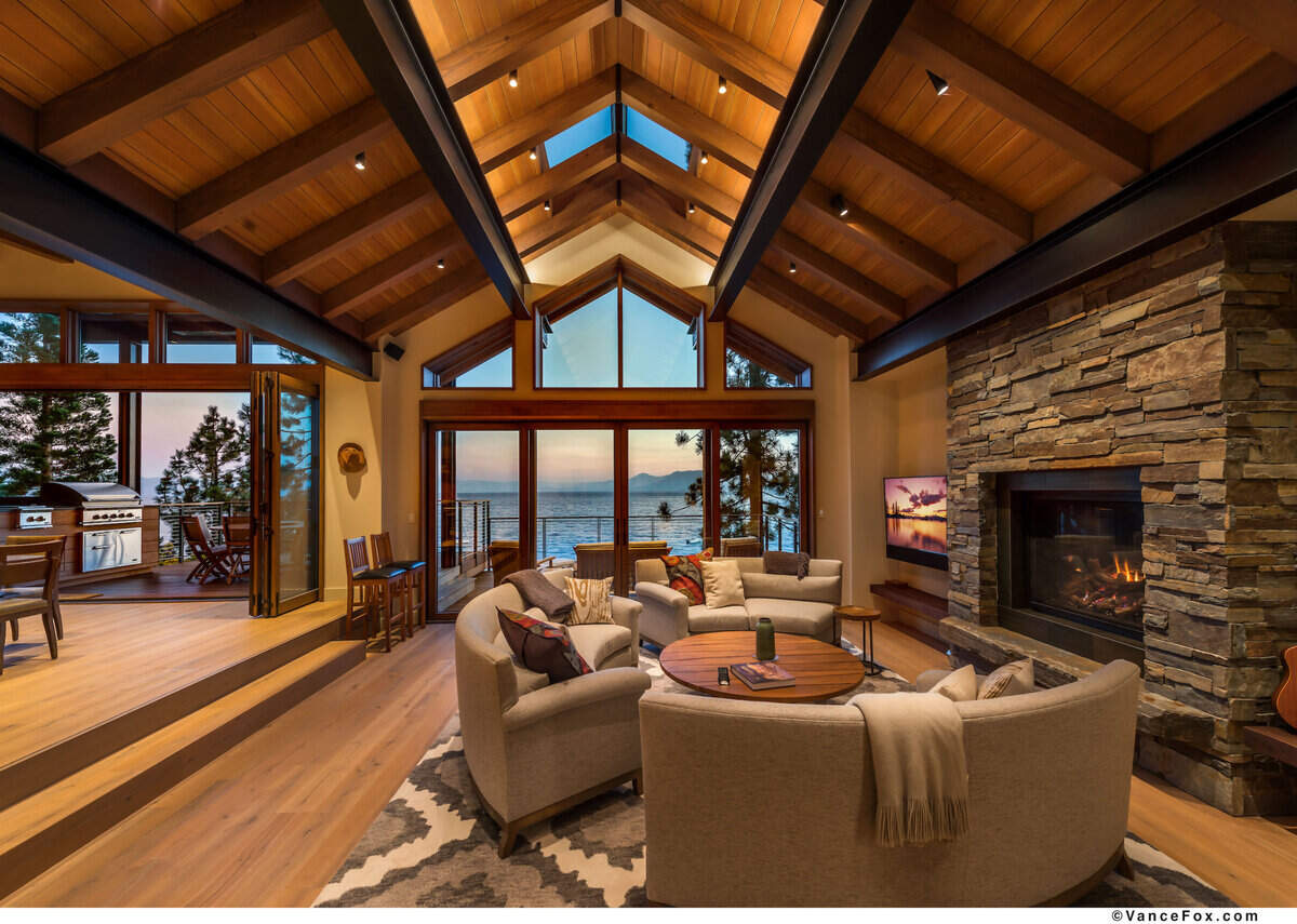Expansive windows offer lake and mountain views.